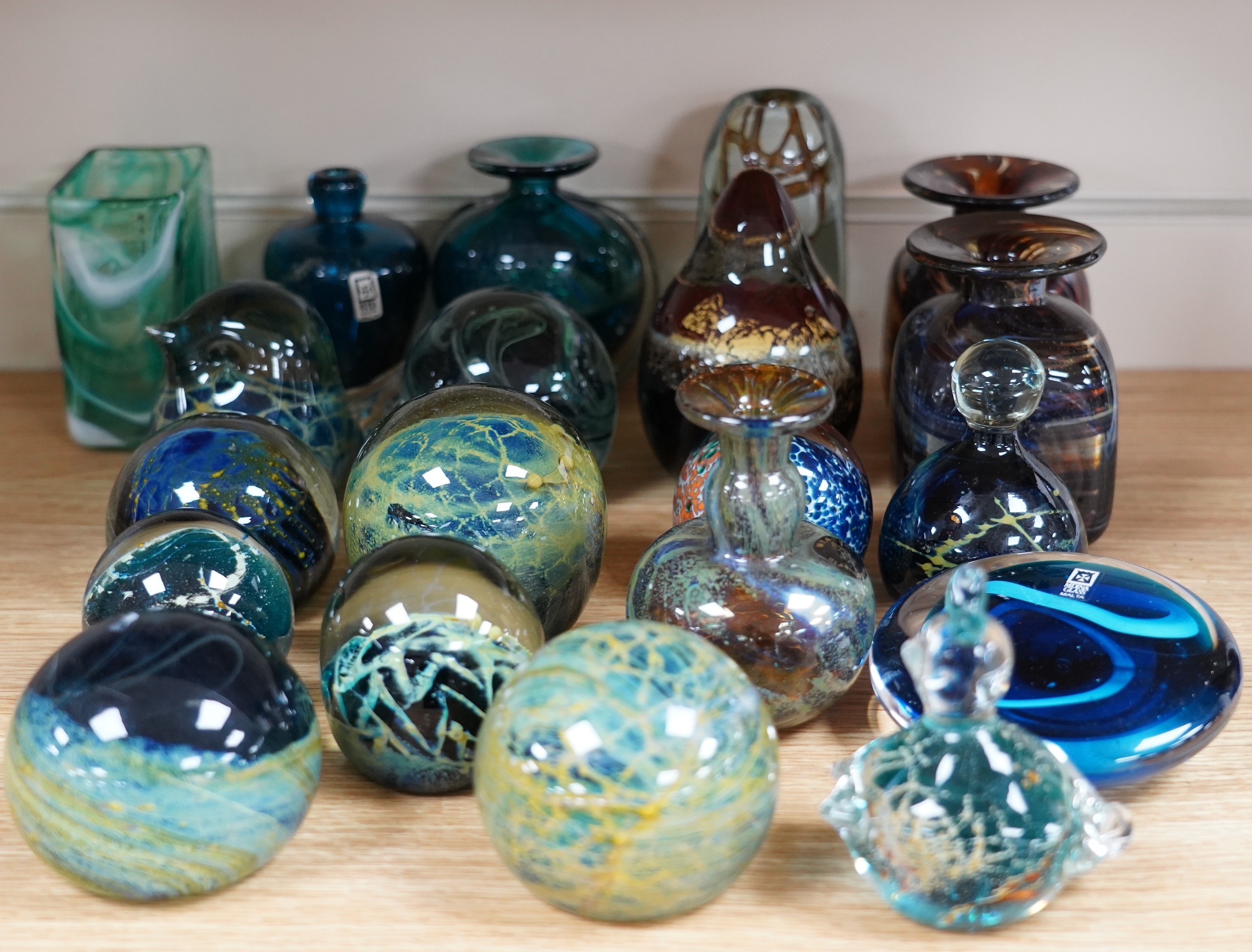 A collection of thirty pieces of Mdina glassware, comprising paperweights and vases, largest 13cm high